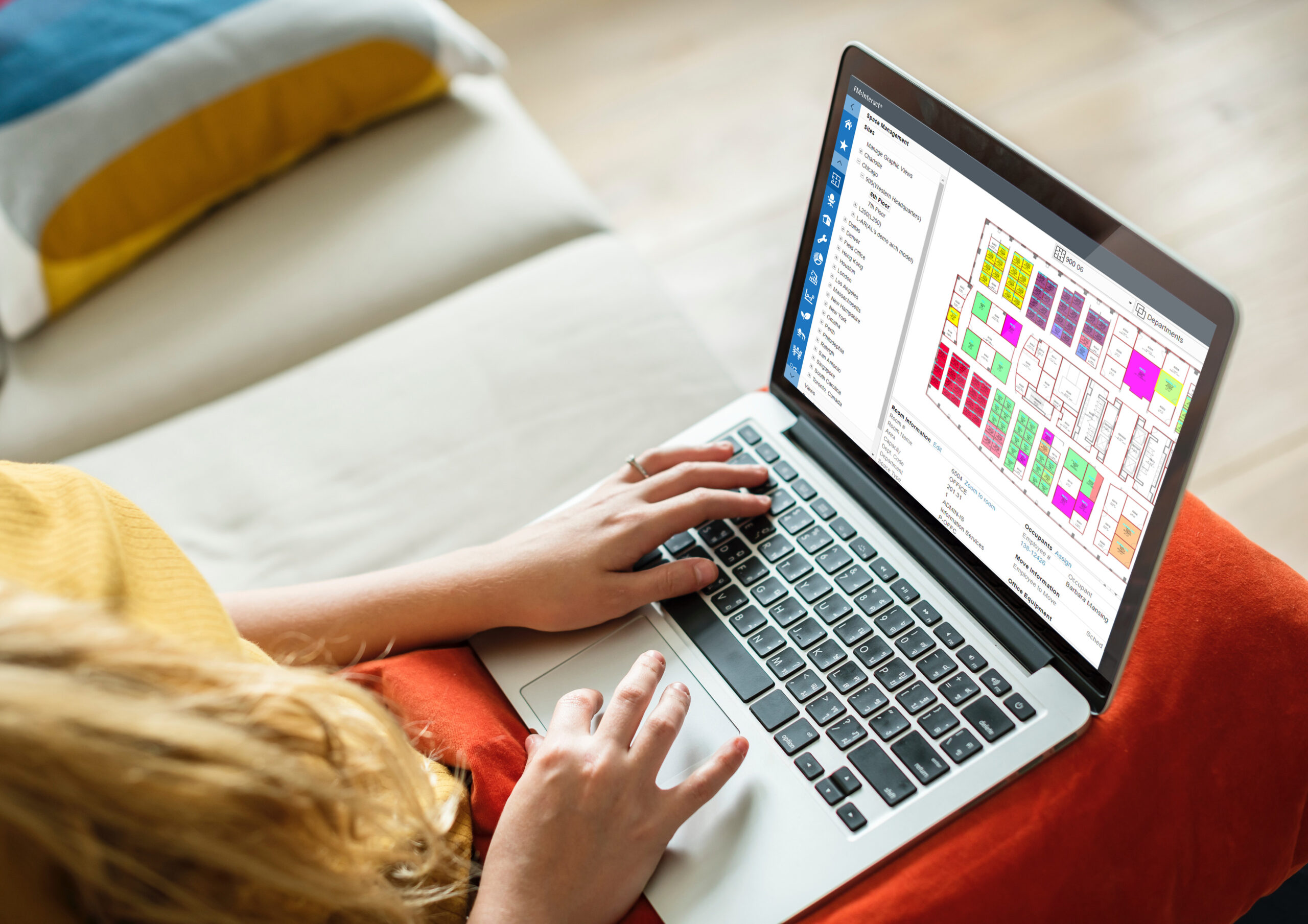 Woman using laptop with floor plan on it
